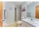 Bathroom featuring a shower, toilet, sink with mirror, and neutral wall color at 1278 Lincoln Dr, Englewood, FL 34224