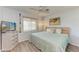 Bedroom featuring a ceiling fan, an updated TV, a window, and a comfortable queen-size bed at 1278 Lincoln Dr, Englewood, FL 34224