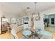 The dining area connects seamlessly with the living room and features a glass table and stylish chairs at 1278 Lincoln Dr, Englewood, FL 34224