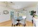 This dining area features a glass table, stylish chairs, modern lighting, and sliding door access to the porch at 1278 Lincoln Dr, Englewood, FL 34224