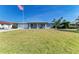 Single-story home with well-kept lawn and an American flag out front; new paint and landscaping at 1278 Lincoln Dr, Englewood, FL 34224