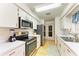 This kitchen has stainless steel appliances, white cabinetry, and a tile backsplash at 1278 Lincoln Dr, Englewood, FL 34224