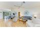 Open-concept living and dining area features hardwood floors, and nautical-themed decorations at 1278 Lincoln Dr, Englewood, FL 34224