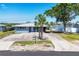 Aerial shot of updated home showing the long driveway and waterfront view at 140 Crestview Dr, Englewood, FL 34223