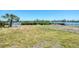 Large backyard with grassy area leading to waterfront at 140 Crestview Dr, Englewood, FL 34223