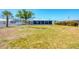 Exterior view of home featuring large backyard with waterfront views at 140 Crestview Dr, Englewood, FL 34223