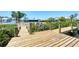 Spacious wooden dock with lush greenery on the waterfront at 140 Crestview Dr, Englewood, FL 34223