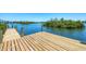 Wooden dock leading to beautiful waterfront views at 140 Crestview Dr, Englewood, FL 34223