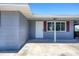 Close up of the home's front entrance featuring a white door and matching trim, flanked by red shutters at 140 Crestview Dr, Englewood, FL 34223
