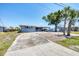 Cozy home with a covered carport, neat landscaping, and a spacious driveway offering convenient parking at 140 Crestview Dr, Englewood, FL 34223