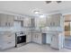 Well-lit renovated kitchen boasts sleek countertops, stainless appliances, and seamless access to the screened-in patio at 140 Crestview Dr, Englewood, FL 34223