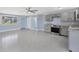 Open kitchen and living area with stainless steel appliances and neutral color palette at 140 Crestview Dr, Englewood, FL 34223