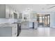 Renovated kitchen with gray cabinets, granite countertops, stainless steel appliances, and access to screened-in lanai at 140 Crestview Dr, Englewood, FL 34223