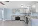 Updated kitchen boasts modern gray cabinetry, sleek stainless steel appliances, and stylish granite countertops at 140 Crestview Dr, Englewood, FL 34223