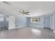 Open-concept living room with fan, window, and fresh paint at 140 Crestview Dr, Englewood, FL 34223