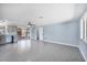 Large living room with light blue walls, and access to kitchen and screened-in patio at 140 Crestview Dr, Englewood, FL 34223