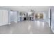 Spacious living area featuring grey speckled floor, neutral blue walls, ceiling fan and natural light at 140 Crestview Dr, Englewood, FL 34223
