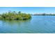 Scenic waterfront view with lush greenery and calm water at 140 Crestview Dr, Englewood, FL 34223