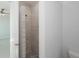 Bathroom with tiled walk-in shower featuring stone floor and a rainfall shower head at 14526 Fort Worth Cir, Port Charlotte, FL 33981