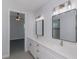Bathroom featuring double vanity with marble countertops and modern lighting fixtures at 14526 Fort Worth Cir, Port Charlotte, FL 33981