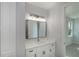 Bathroom vanity with modern fixtures and a large mirror reflecting ample lighting at 14526 Fort Worth Cir, Port Charlotte, FL 33981