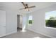 Bedroom with a ceiling fan and two windows offering natural light and views at 14526 Fort Worth Cir, Port Charlotte, FL 33981