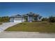 Beautiful single-story home with a well-manicured lawn and inviting entrance at 14526 Fort Worth Cir, Port Charlotte, FL 33981