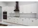 Close up on the kitchen featuring modern backsplash, white cabinets and granite countertops at 14526 Fort Worth Cir, Port Charlotte, FL 33981