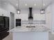 Kitchen island with white cabinetry, granite countertops and stylish pendant lighting at 14526 Fort Worth Cir, Port Charlotte, FL 33981