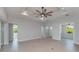 Spacious living room featuring a tray ceiling with fan and light hardwood floors at 14526 Fort Worth Cir, Port Charlotte, FL 33981