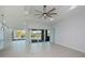 Bright living room featuring a modern ceiling fan and large glass doors leading to the screened in patio at 14526 Fort Worth Cir, Port Charlotte, FL 33981