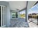 Expansive screened-in patio for relaxation with views of a pool and lake at 14526 Fort Worth Cir, Port Charlotte, FL 33981