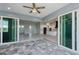 Stunning outdoor patio with tile flooring seamlessly flowing to the interior kitchen and living space at 14526 Fort Worth Cir, Port Charlotte, FL 33981