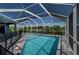 A beautiful screened-in pool with water views, perfect for relaxing and enjoying the outdoors at 14526 Fort Worth Cir, Port Charlotte, FL 33981