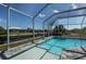 Stunning screened-in pool, featuring a gradual entry, ideal for leisure and water view enjoyment at 14526 Fort Worth Cir, Port Charlotte, FL 33981