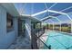 A refreshing screened-in pool and covered patio with beautiful outdoor landscape views at 14526 Fort Worth Cir, Port Charlotte, FL 33981