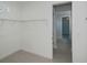 Walk-in closet with shelving and tile flooring, providing ample storage space at 14526 Fort Worth Cir, Port Charlotte, FL 33981