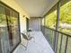 Screened-in balcony with seating and sliding glass doors for easy indoor-outdoor living at 149 Englewood Isles Pkwy # 609, Englewood, FL 34223