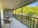 Inviting balcony with a table and chairs, overlooking lush greenery at 149 Englewood Isles Pkwy # 609, Englewood, FL 34223