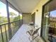 Private screened-in balcony with seating and views of palm trees at 149 Englewood Isles Pkwy # 609, Englewood, FL 34223