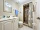 Bathroom features a vanity, toilet, and a tiled walk-in shower with a curtain at 149 Englewood Isles Pkwy # 609, Englewood, FL 34223