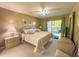 Cozy bedroom with balcony access, ceiling fan, and soft, neutral tones at 149 Englewood Isles Pkwy # 609, Englewood, FL 34223