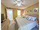 Comfortable bedroom with a ceiling fan and easy access to an ensuite bathroom at 149 Englewood Isles Pkwy # 609, Englewood, FL 34223