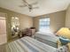 Inviting bedroom with twin beds, neutral walls, and ceiling fan for comfort at 149 Englewood Isles Pkwy # 609, Englewood, FL 34223