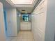 Hallway with tile floors, built in storage and a passthrough window to the lanai at 149 Englewood Isles Pkwy # 609, Englewood, FL 34223