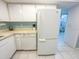 Bright kitchen with white refrigerator and dishwasher at 149 Englewood Isles Pkwy # 609, Englewood, FL 34223