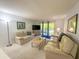 Bright living room with comfortable seating and balcony access with a scenic view at 149 Englewood Isles Pkwy # 609, Englewood, FL 34223