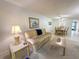 Comfortable living room with sofa, coffee table, and dining area in the background at 149 Englewood Isles Pkwy # 609, Englewood, FL 34223