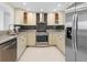 Modern kitchen featuring stainless steel appliances and granite countertops at 1493 Kathleen Pl, Englewood, FL 34223
