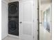 Efficient laundry area featuring a stacked washer and dryer unit at 1493 Kathleen Pl, Englewood, FL 34223